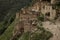 Ancient ruin of stone city in highlands in Dagestan, details of abandoned buildings, street and dirt road on majestic mountains.