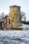 Ancient ruined tower by the river in winter, Russia, Pskov