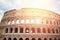 Ancient ruins Colosseum Rome, Italy, background blue sky with clouds, sunset light