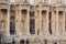 Ancient ruins of Ephesus in Turkey with tourists checking out the old sculpted columns