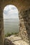 Ancient ruins, fascinating window into the open blue sky and water