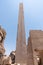 Ancient ruins of Karnak temple in Egypt in the summer, Obelix and statues of Ramses II at the first pylon of the Luxor