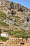 Ancient ruins and an Orthodox chapel on a rocky slope