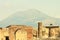 Ancient ruins in Pompeii against backdrop of great volcano Vesuvius,  Italy.