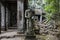 Ancient ruins of Preah Khan temple in Angkor Wat complex, Cambodia. Headless statue of demolished palace.