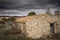 Ancient rustic country house on a cloudy day