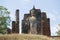 Ancient sculpture of a Buddha on a hill. Sukhothai, Thailand