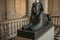 Ancient sculpture of Egyptian sphinx sitting at the Louvre Museum in Paris.