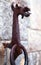 Ancient sculpture forged metal rusty dragon with handle in form