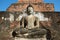 Ancient sculpture of a sitting Buddha close up. Fragment of ruins of the Buddhist temple Wat Mahathat. Sukhothai, Thailand