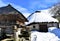 Ancient snowy palloza house and wooden horreo granary galician granary. Piornedo, Ancares, Galicia, Spain.