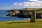 Ancient Standing stone above rugged and wild coastline