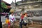 Ancient statue bali style and lifestyle of Balinese people walking on street near Goa Gajah temple or Elephant Cave at Ubud city