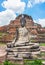 Ancient statues of sitting Buddha image in front of remains of main Phra Pang at Wat Mahathat