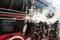 Ancient steam locomotive in steam. Live steam around mechanical