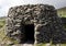 Ancient stone beehive hut, or clochan, a stone dry hut in rural Ireland