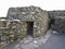 Ancient stone beehive hut colony of clochans, stone dry huts in rural Ireland