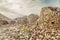 Ancient stone beehive tombs with Jebel Misht mountain in the background, archaeological site near al-Ayn, sultanate Oman