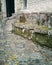 Ancient stone bench in front of the entrance. Moss on stones