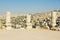 Ancient stone blocks of the ruined columns at the Citadel of Amman with the city at the background in Amman, Jordan.