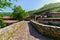 Ancient stone bridge crossing a river in medieval village. Barcena Mayor Santander