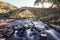 Ancient stone bridge over flowing river in Corsica