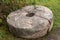 Ancient stone millstone split in half