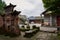 Ancient stone monument and column bases by path in cloudy morning