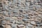 Ancient stone road surface. Pavement. Cobblestones and sand