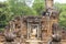 Ancient stone ruin in Angkor Wat temple. Small shrine with lion statue. Khmer heritage temple ruin in jungle.