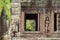 Ancient stone ruin of Banteay Kdei temple, Angkor Wat, Cambodia. Ancient temple window to green forest