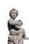 Ancient stone sculpture of naked cherub playing lute on white background