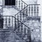 Ancient stone staircase with ornate wrought handrail