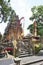 Ancient stone temple with carved details and colorful banners in Bali Indonesia