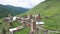 Ancient stone towers and Ushguli village at the foot of Mt. Shkhara. Picturesque and gorgeous scene. Rock tower towers and old hou