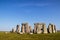 Ancient Stonehenge - standing rocks - in Great Britain under a beautiful blue sky on a sunny day with contrasting shadows