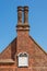 Ancient Sundial and chimney stack on the Moot Hall in Aldeburgh.