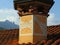 ancient sundial with hour numbers on the chimney of a house