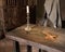 Ancient table with candle, rosary and cross in priest room