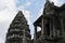 Ancient temple Angkor Wat gate and tower view. Mossy stone temple Angkor Wat on sky background.