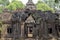 Ancient temple gate in Angkor Wat. Stone portal with bas-relief decor. Angkor Wat landscape.