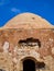 Ancient temple ruins, small entrance, blue sky background