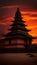 Ancient Temple Silhouetted Against a Fiery Sunset Sky