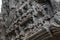 Ancient temple stone carved bas-relief in Angkor Wat. Praying people bas-relief closeup. Angkor Wat temple architecture