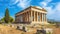 Ancient temple in summer in Greece, classical Greek ruins on blue sky background, landscape with old building and stones. Theme of