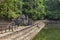 Ancient temple in tropical landscape, Angkor Wat complex. Buddhist or hindu temple Neak Pean with pond and trees.