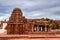 Ancient temple with unique stone wall art and dramatic sky