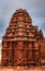 Ancient temple with unique stone wall art and dramatic sky