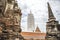 Ancient thai white pagoda is standing in between red brick ancient ruins pagodas in Ayutthaya,Thailand