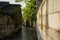 Ancient tile-roofed house in stone alley after morning rain